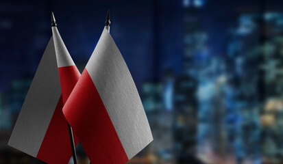 Small flags of the Poland on an abstract blurry background