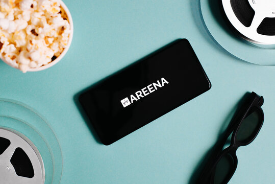 Yle Areena streaming service mobile app on smartphone screen, 3D glasses, film reels, popcorn cup. Online entertainment and leisure. Astana, Kazakhstan 25.01.2023
