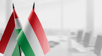 Small flags of the Hungary on an abstract blurry background