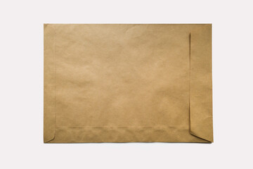 a large envelope made of kraft paper on a white background. place for text - obrazy, fototapety, plakaty