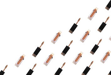 Creative pattern made of nude liquid matt lipstick on white background. Top view. Flat lay. Make up and decorative cosmetic concept
