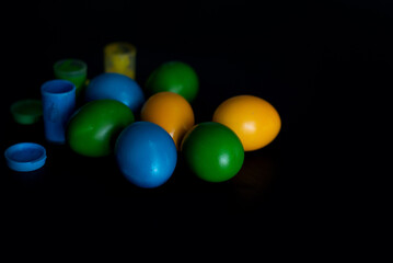 Easter eggs in nest painted by hand in blue color on dark background. Chicken and quail eggs catholic and orthodox easter holiday