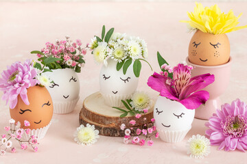 Funny Easter eggs with painted cute face and flowers