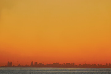 The sun sets over the Mozambique capital city of Maputo as seen from Inhaca Island.