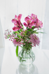 Vase with pink spring flowers