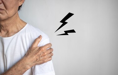 Pain in the shoulder joint of Asian elder man. Concept of frozen shoulder.