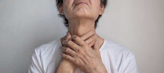Tightness at the neck of Asian man. Concept of sore throat, pharyngitis, laryngitis, esophagitis,...