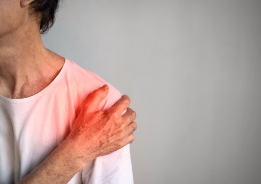 Pain in the shoulder joint of Asian elder man. Concept of frozen shoulder.