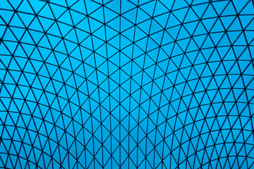 Abstract triangle cyan and blue roofing pattern, Modern steel and glass dome roof structure architecture © kaiskynet
