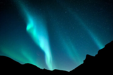 Aurora borealis. Northern lights in winter mountains. Sky with polar lights and stars