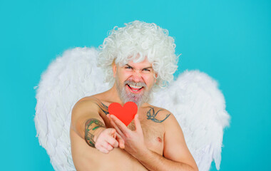 Valentines day cupid. Male angel with red paper heart pointing to you. Cupid in valentine day.