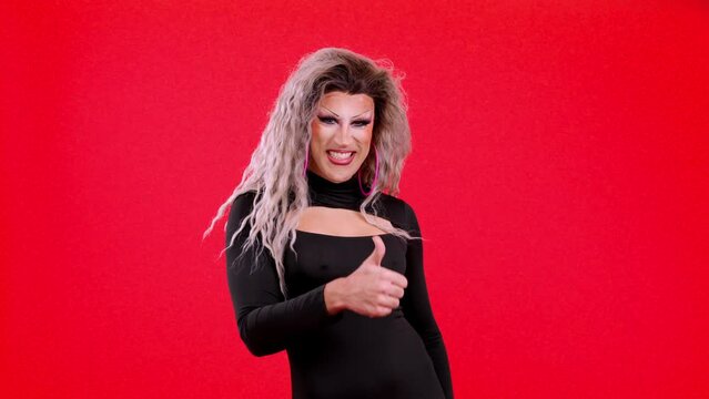 Transgender person with make up gesturing approval raising thumb up