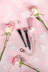Woman beauty objects. Stone tools for Guasha massage, roses, jewelry, cosmetic tube, brushes.
