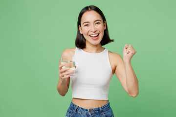 Young woman wear white clothes hold drink clear fresh pure still water from glass do winner gesture...