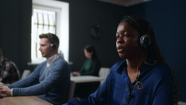 african woman working in call-center or telemarketing department, consulting and helping line
