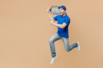 Full body sideways delivery guy employee man wearing blue cap t-shirt uniform workwear work as...