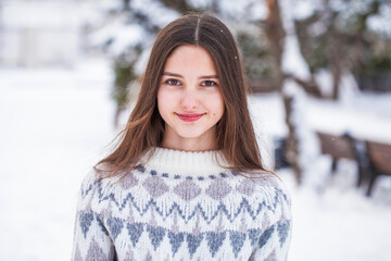 Portrait of a young beautiful girl in a woolen sweater
