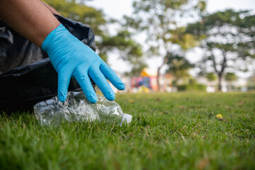 Volunteer man collecting trash and reusing plastic cleanup to recycle