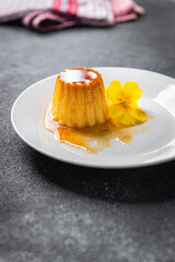 flan sweet dessert cream, caramel, lemon healthy meal food snack on the table copy space food background rustic top view