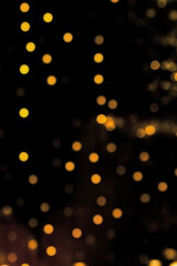 Fototapeta na wymiar glitter vintage lights, bokeh background. Black and gold