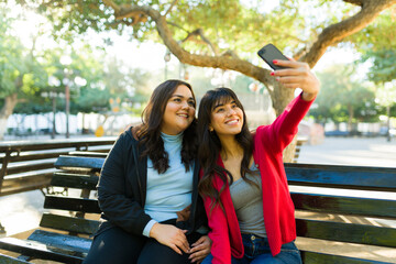 Cheerful best friends hanging out taking a selfie