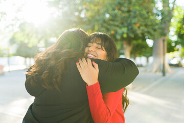 Rear view of best friends embracing for their beautiful friendship