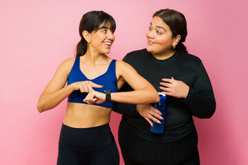 Happy young women working out together