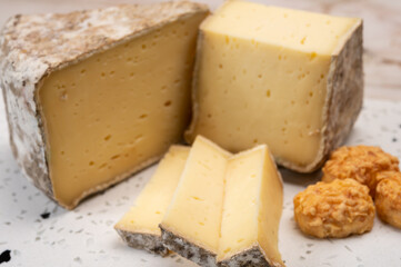 Pieces of cheese tomme de montagne or tomme de savoie made from cow milk in French Alps