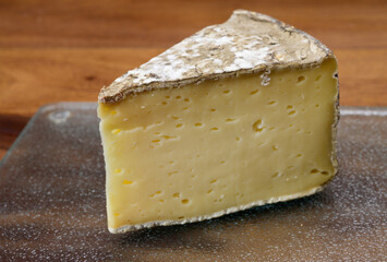 Pieces of cheese tomme de montagne or tomme de savoie made from cow milk in French Alps