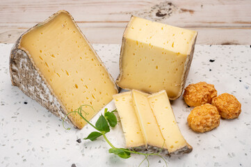 Pieces of cheese tomme de montagne or tomme de savoie made from cow milk in French Alps