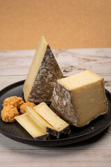 Pieces of cheese tomme de montagne or tomme de savoie made from cow milk in French Alps