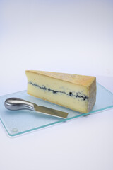 French semi-soft cow milk cheese morbier from Franche-Comte region with thin black layer and strong aroma