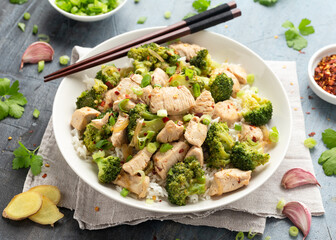 Stir fried Chicken and Broccoli with rice in white plate