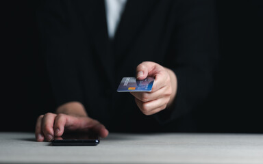 Online payment, human hand holding credit card and using smartphone for online shopping.