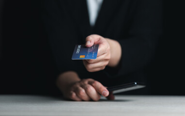 Online payment, human hand holding credit card and using smartphone for online shopping.