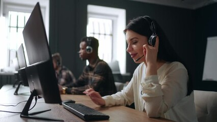 multiethnic people work in call center of big company, woman with headset answer on phone calls - Powered by Adobe