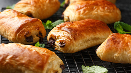 Homemade pain au chocolat freshly baked and cooling on rack