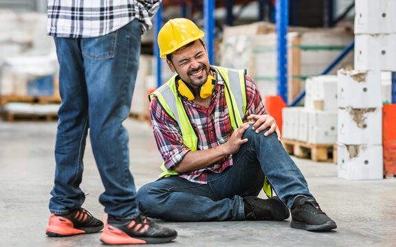 Selective focus, Portrait Male Engineer or worker wearing safety hard hat, getting dangerous risk accident, njured or pain on knee while working in factory. Industry Concept.