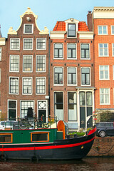 Naklejka premium Amsterdam, typical crooked houses facing the canals, Netherlands