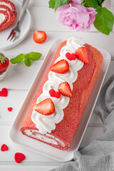 Red velvet rolled cake with fresh strawberries and cream cheese. Valentine's Day dessert. Selective...