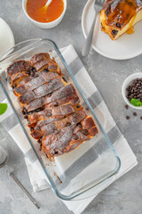Homemade bread pudding with chocolate chips on a gray concrete background. Selective focus, copy space.