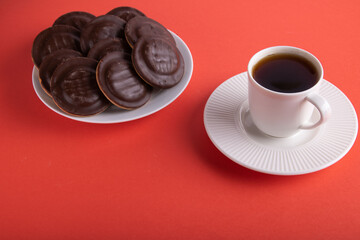 photo cookies with chocolate lying on a plate with a cup of coffee next to them