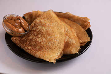 photo thin pancakes folded into triangles and boiled condensed milk