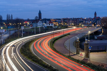 Long exposure of evening traffic on a motorway seen from train station Halfweg Zwanenburg in The Netherlands