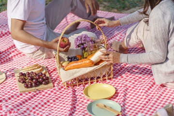 In love couple enjoying picnic time in park outdoors Picnic. happy couple relaxing together with picnic Basket