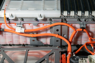 High-tech EV battery rear assembly, close-up of heating system, wiring, and cells with subframe....