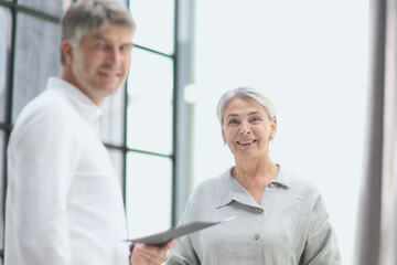 Confident smiling businessman posing at modern office