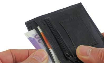 hand holding wallet with money