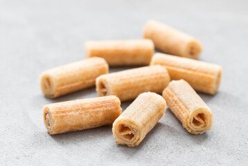 Vegan sweet waffle rolls. Light grey background. Closeup
