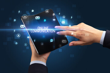 Businessman holding a foldable smartphone, social media concept